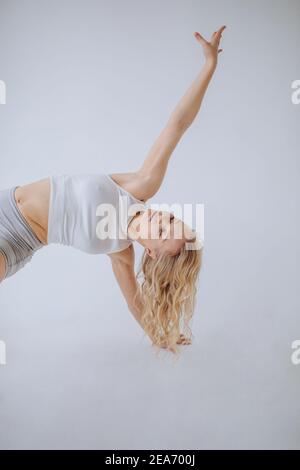 Close-up of a woman in casual sportswear doing a side plank Stock Photo