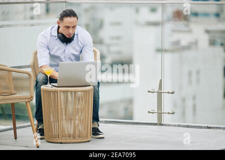 Man programming on rooftop Stock Photo