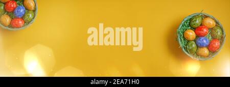 Banner for easter card. Flat lay composition with Easter eggs on yellow background. Stock Photo