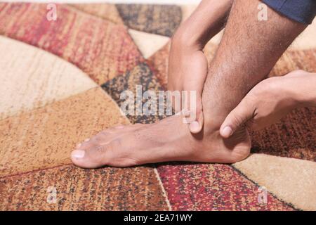 Close up young man suffering feet pain  Stock Photo
