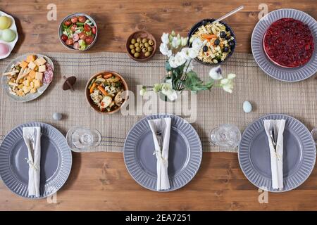 Top down view at wooden table with simple and elegant place setting served for Easter dinner, copy space Stock Photo