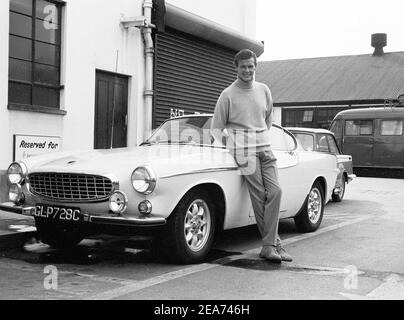 Volvo P1800. A sports car manufactured by Volvo Cars wtih production start 1961 and ending 1973. Styling was by swedish designer Pelle Pettersson. The car was indroduced at the Geneva Motor Show in 1961. The model P1800 sold 47492 cars.The P1800  became widely known when driven by then future James Bond actor Roger Moore as Simon Templar in the television series The Saint. Pictured Sir Roger Moore , 1927-2017 during the filming of the tv-series The Saint, posing with a Volvo P1800. The Saint ran from 1962 for six seasons and 118 episodes. 1966 Stock Photo