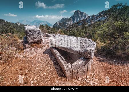 Destroyed greek tombs and ancient burials in the ancient city of Termessos in Antalya province in Turkey. Famous tourist and archaeology spot Stock Photo