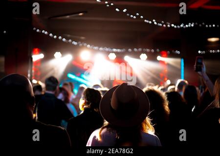 Photo of many people enjoying rock concert in nightclub Stock Photo