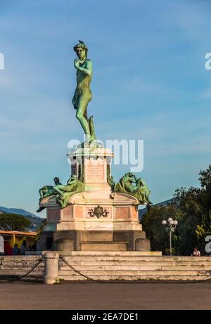 Nice view of a black bird sitting on the bronze statue of a Michelangelo's David replica in the famous square Piazzale Michelangelo, located in the... Stock Photo