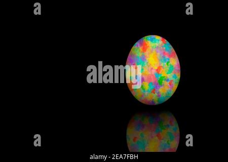 Easter egg painted with different colors, isolated on black bakcground. Stock Photo