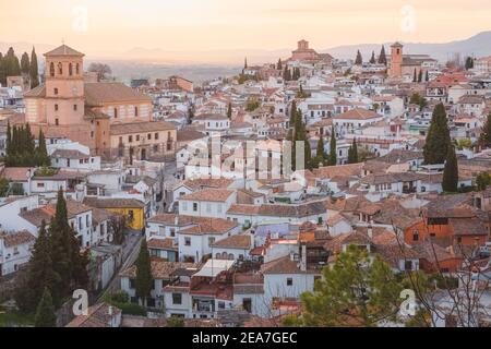 Old town sunset cityscape view of terracotta rooftops and the Church of San Salvador in the historic Moorish or Arab Quarter (albaicin) in Granada, An Stock Photo