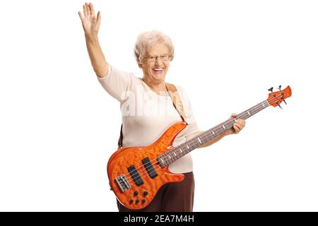 Elderly woman with an electric bass guitar waving at the camera isolated on white background Stock Photo