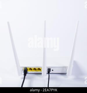 White wifi router connected to the network, on a white background. Stock Photo