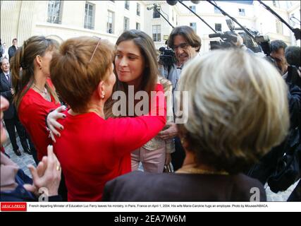 French departing Minister of Education Luc Ferry leaves his ministry, in Paris, France on April 1, 2004. His wife Marie-Caroline hugs an employee. Photo by Mousse/ABACA. Stock Photo