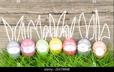 Funny bunnies easter eggs with protective mask. Covid pandemic quarantine concept Stock Photo