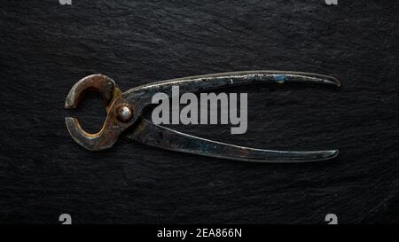 Rusty tool on slate background. Stock Photo