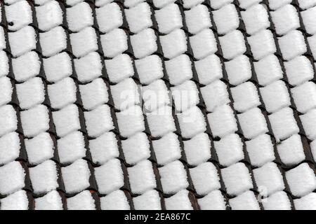 Snow on roof tiles. Stock Photo