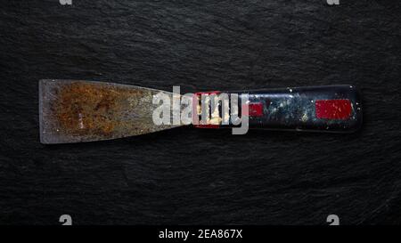 Rusty tool on slate background. Stock Photo