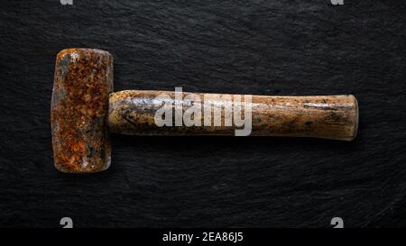 Rusty tool on slate background. Stock Photo