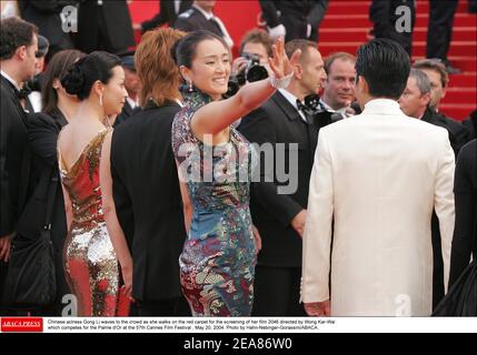 Chinese actress Gong Li waves to the crowd as she walks on the red carpet for the screening of her film 2046 directed by Wong Kar-Wai which competes for the Palme d'Or at the 57th Cannes Film Festival , May 20, 2004. Photo by Hahn-Nebinger-Gorassini/ABACA. Stock Photo