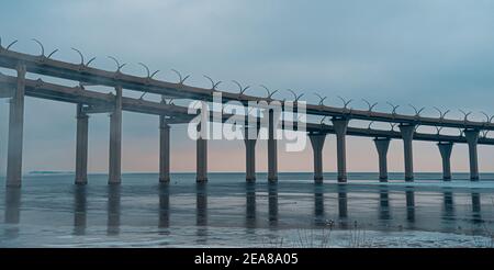 The silhoette of the Western High-Speed Diameter located in the Finnish bay near the Kanonersky Island. Stock Photo