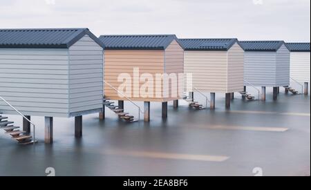 Line of beach huts up on stilts at high tide with smoothed water beneath Stock Photo