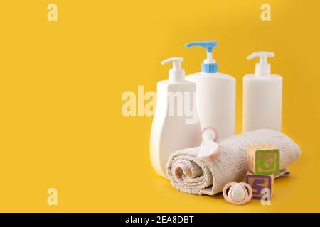 Baby hygiene and bath utensils on yellow background Stock Photo