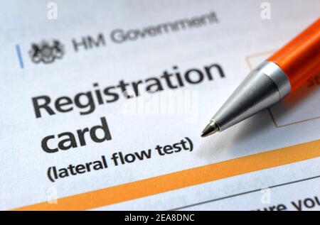 GOVERNMENT COVID 19 LATERAL FLOW TEST REGISTRATION CARD WITH PEN RE CORONAVIRUS VIRUS TESTING PANDEMIC VACCINE VACCINATIONS ETC UK Stock Photo