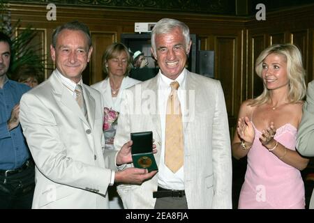 paris Mayor Bertrand Delanoe (L), French actor Jean-Paul Belmondo and his wife Natti pictured during the opening ceremony of the 2nd Festival Paris Cinema at the Hotel de Ville (City Hall) in Paris-France on June 28, 2004. On the occasion Delanoe honored Belmondo with the Medal of the City of Paris. Photo by Laurent Zabulon/ABACA. Stock Photo