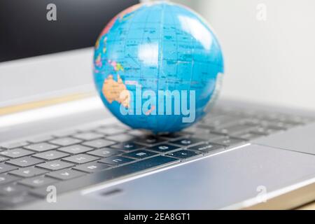 Global business and communications Concept, Laptop and World Stock Photo