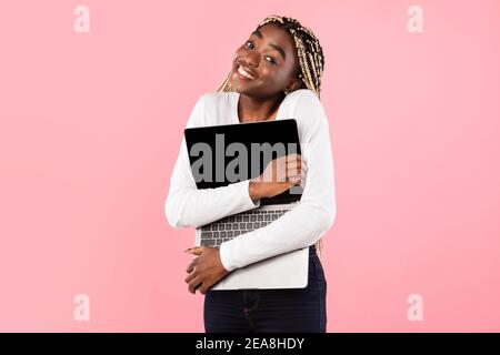 Technology Lover. Excite black woman hugging personal computer Stock Photo