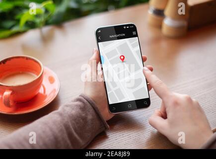 Woman Using Navigation Application On Smartphone Sitting In Cafe, Closeup Stock Photo