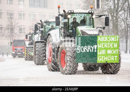 Berlin, Berlin, Germany. 8th Feb, 2021. A sign with the inscription 'Sorry! But otherwise we will not be heard' is attached to a tractor as farmers and Agriculture workers drive in convoy with tractors during heavy snowfall through the government district in Berlin protesting against the German governments agriculture policies. Credit: Jan Scheunert/ZUMA Wire/Alamy Live News Stock Photo