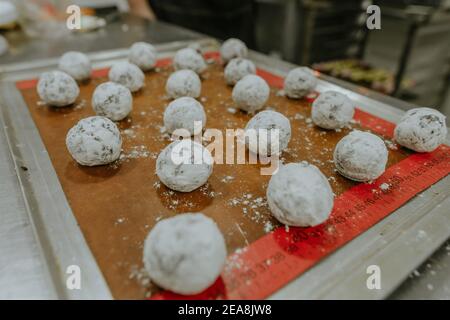 Chocolate cookies on the baking sheet ready for baking in the confectionery studio Stock Photo