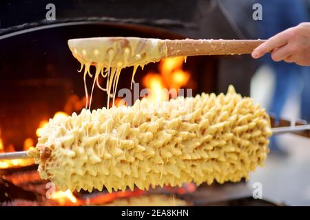 Traditional Lithuanian tree cake called sakotis baked at Kaziukas, an annual Easter fair in Vilnius, Lithuania Stock Photo