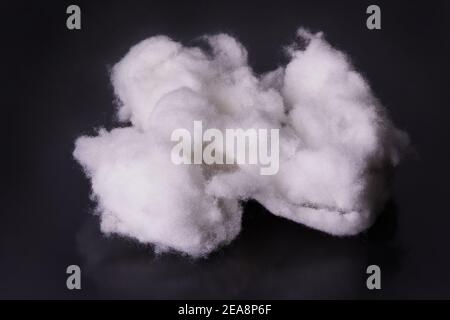 Modern bio-polymeric synthetic filler  for textile manufacturing on a black background. It is an alternative down Stock Photo