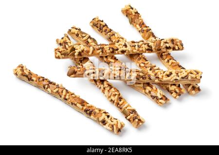 Heap of fresh baked crunchy cheese sticks with a variety of seeds as snack close up isolated on white background Stock Photo