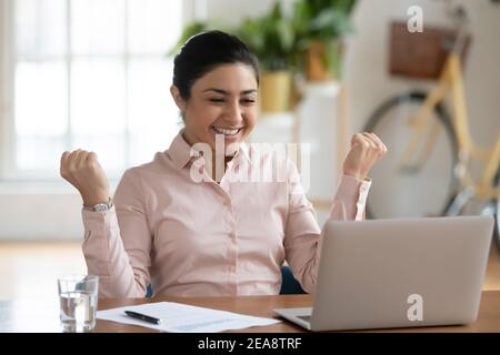 Happy professional celebrating success and making winner gesture Stock Photo