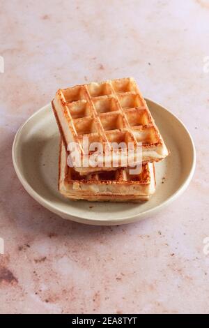Stack of two plain Belgian waffles on a small plate. Stock Photo