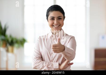 Confident young Indian woman making thumb up Stock Photo