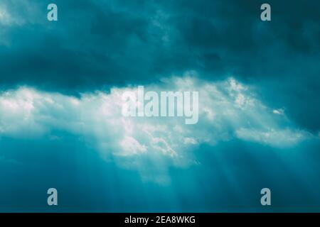 Sunrays Through Blue Rainy Dramatic Sky. Natural Abstract Background Stock Photo