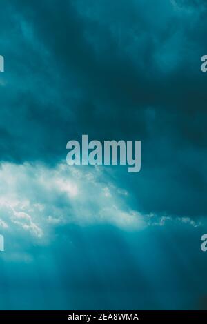 Sunrays Through Blue Rainy Dramatic Sky. Natural Abstract Background Stock Photo