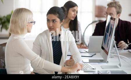 Serious marketing professionals discussing and analyzing charts Stock Photo