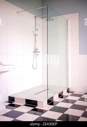 Classic, contemporary living: a double shower in a bathroom finished with black and white floor tiles. Stock Photo