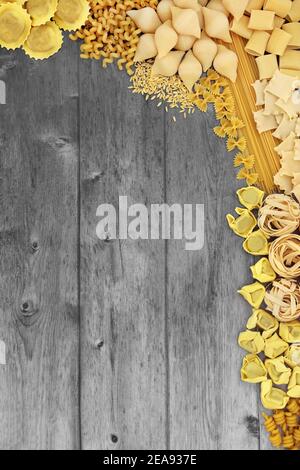 Large collection of Italian pasta varieties on silver grey rustic wood background. Flat lay, top view, copy space. Stock Photo