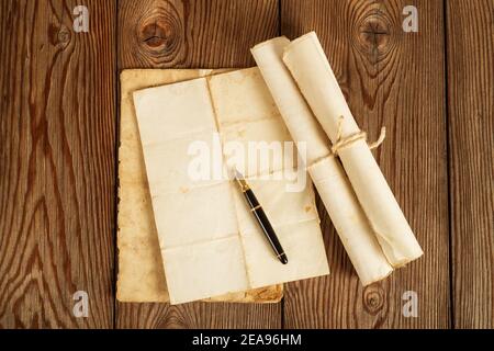 Fountain pen  with old sheets on wood background Stock Photo
