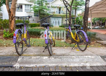 Jakarta, Indonesia - June 24, 2020: Rusty unused communal bicycles to encourage people to use instead of cars for transport in an Indonesian middle Stock Photo