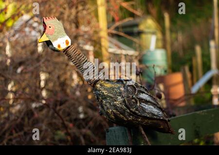 Rusty cockerel garden ornament in the winter sun Stock Photo