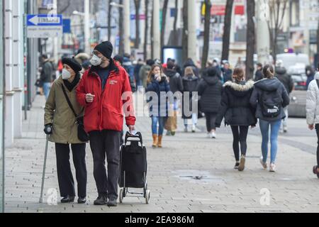 Vienna, Austria. 8th Feb, 2021. Pedestrians walk on a shopping street in Vienna, Austria, Feb. 8, 2021. The Austrian government has announced measures of 'gentle relaxation' -- going into effect from Feb. 8 -- in lieu of the country's third lockdown that has been in place since Dec. 26, 2020 to contain the coronavirus.Schools, stores, and cultural venues such as museums and zoos were allowed to reopen under strict precautionary measures. Credit: Guo Chen/Xinhua/Alamy Live News Stock Photo