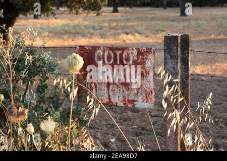 rusty hunting ground sign in spanish Stock Photo