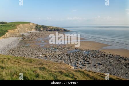 Overview of Southerndown Beach and Dunraven Bay with a  wave cut limestone pavement exposed at low tide, Glamorgan Heritage Coast, South Wales, UK. Stock Photo