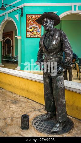 Cayo Santa Maria, Cuba, February 2016 - Street mime in black cowboy outfit standing in a corner of La Estrella waiting to entertain visiting tourists Stock Photo