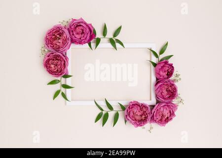 Empty flower frame made of rose on a beige background. Greeting card  template with copyspace. Floral concept Stock Photo - Alamy