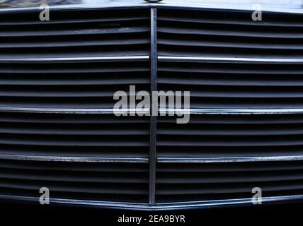 Closeup of car grill shiny chrome surface of vintage retro vehicle car part concept with lots of copy space for text Stock Photo